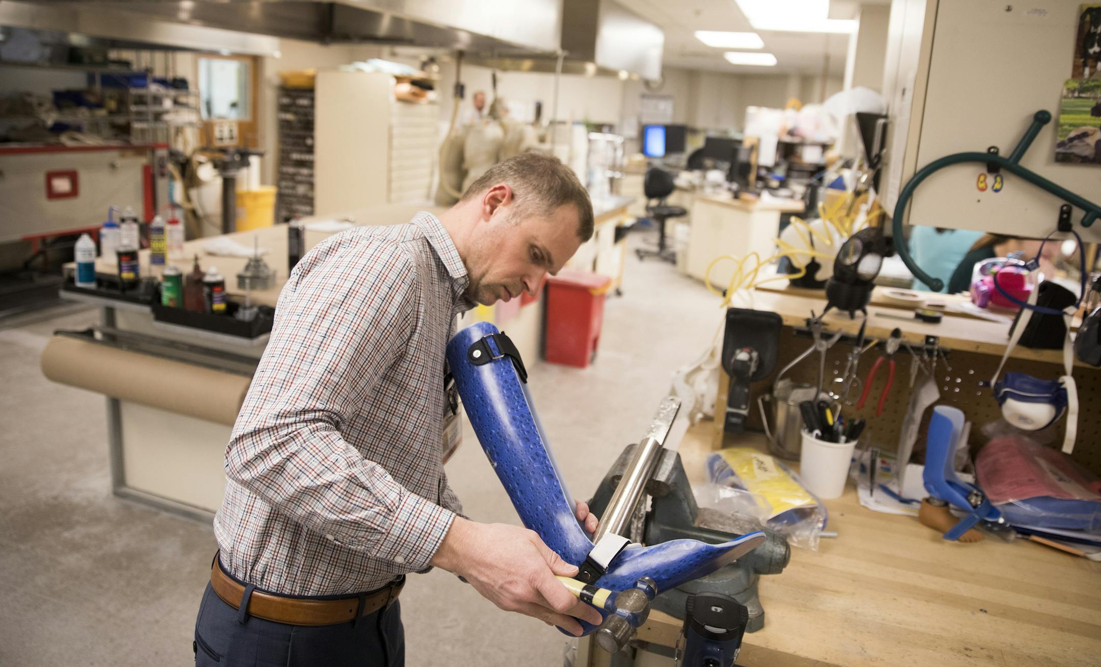 Aaron Rasmussen, a certified orthotist, makes some adjustments to a leg brace in the lab at Gillette Children's in St. Paul. ] LEILA NAVIDI &#xef; leila.navidi@startribune.com BACKGROUND INFORMATION: The custom-design lab at Gillette Children's Hospital in St. Paul on Tuesday, February 6, 2018.