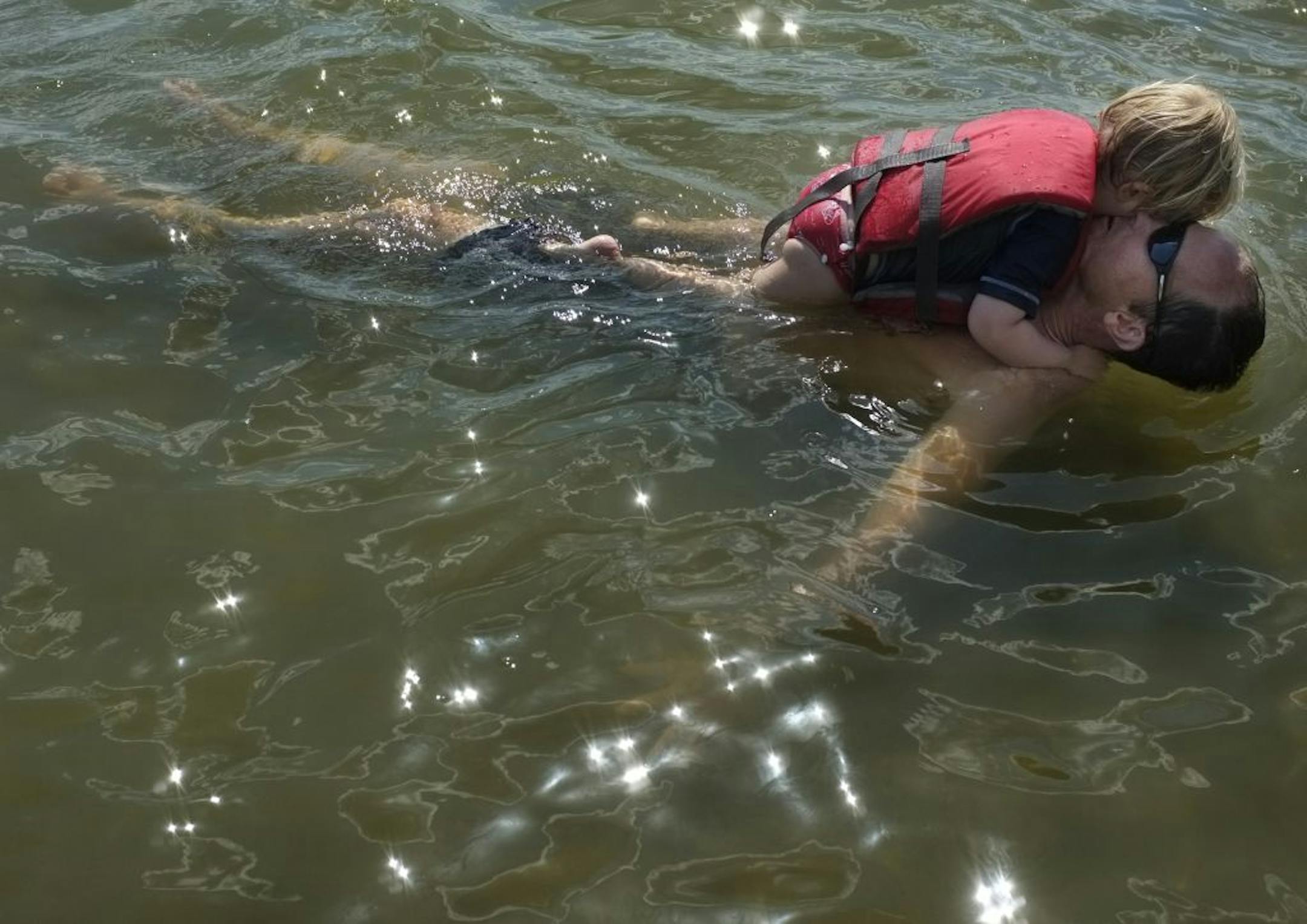 Nicholas Case, 2, nuzzled up to his dad, Alex, who loves Lake Minnewashta. "It's beautiful sand. The water is clean. I don't think a lot of people know about it."