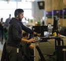 Piero Soria, a data analyst for global services operations, stands at his desk as he works at Groupon in Chicago on Wednesday, Nov. 14, 2018. The stor