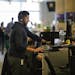 Piero Soria, a data analyst for global services operations, stands at his desk as he works at Groupon in Chicago on Wednesday, Nov. 14, 2018. The stor