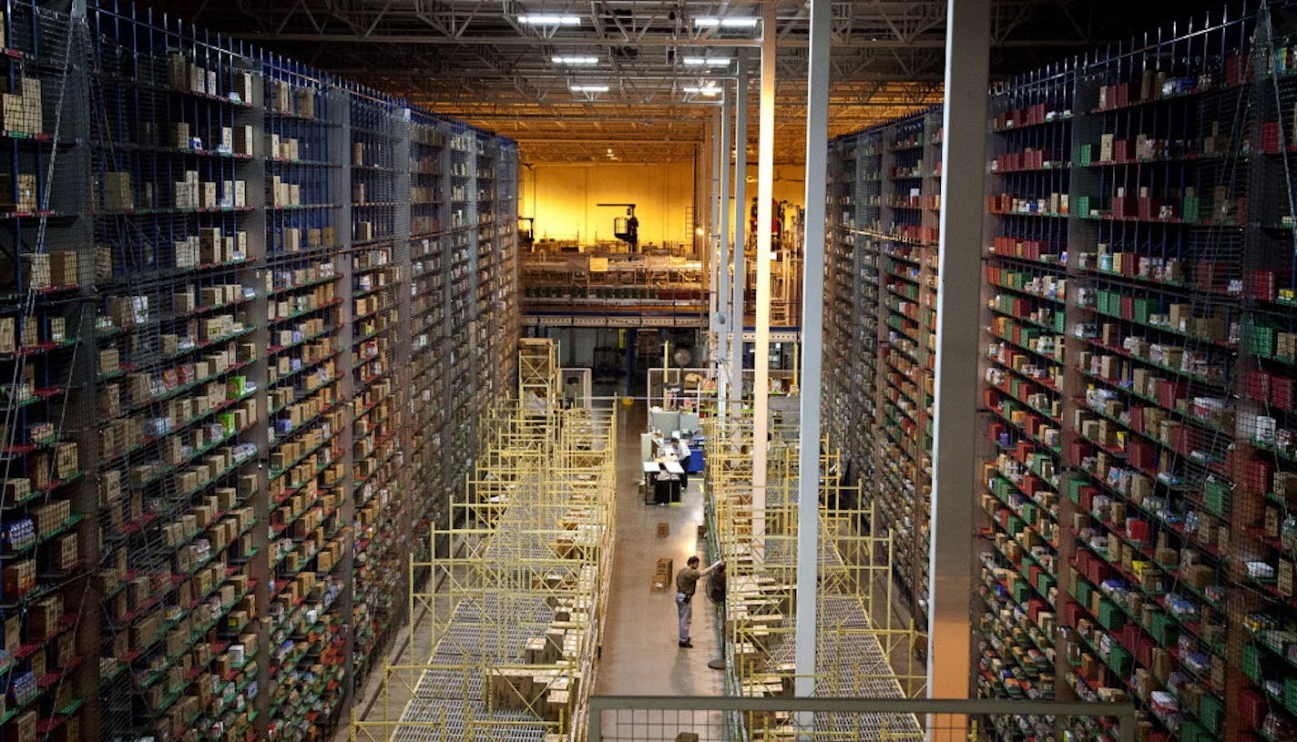 An employee at Supervalu Inc. stands in part of a warehouse at a distribution center in Hopkins, Minnesota on Monday, Jan. 9, 2012. Inventories at U.S. wholesalers rose 0.1 percent following a 1.2 percent revised gain in October, Commerce Department figures showed today in Washington. Photographer: Ariana Lindquist/Bloomberg ORG XMIT: 136862452