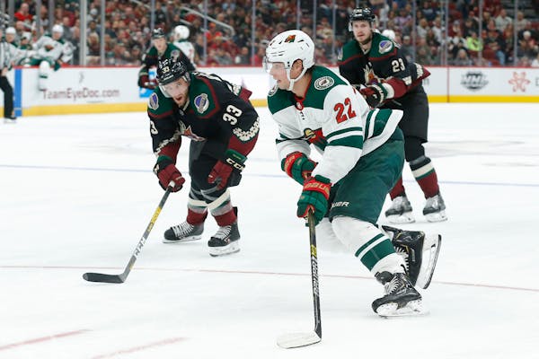 Minnesota Wild left wing Kevin Fiala carries the puck in front of Arizona Coyotes defenseman Alex Goligoski (33) in the third period during an NHL hoc
