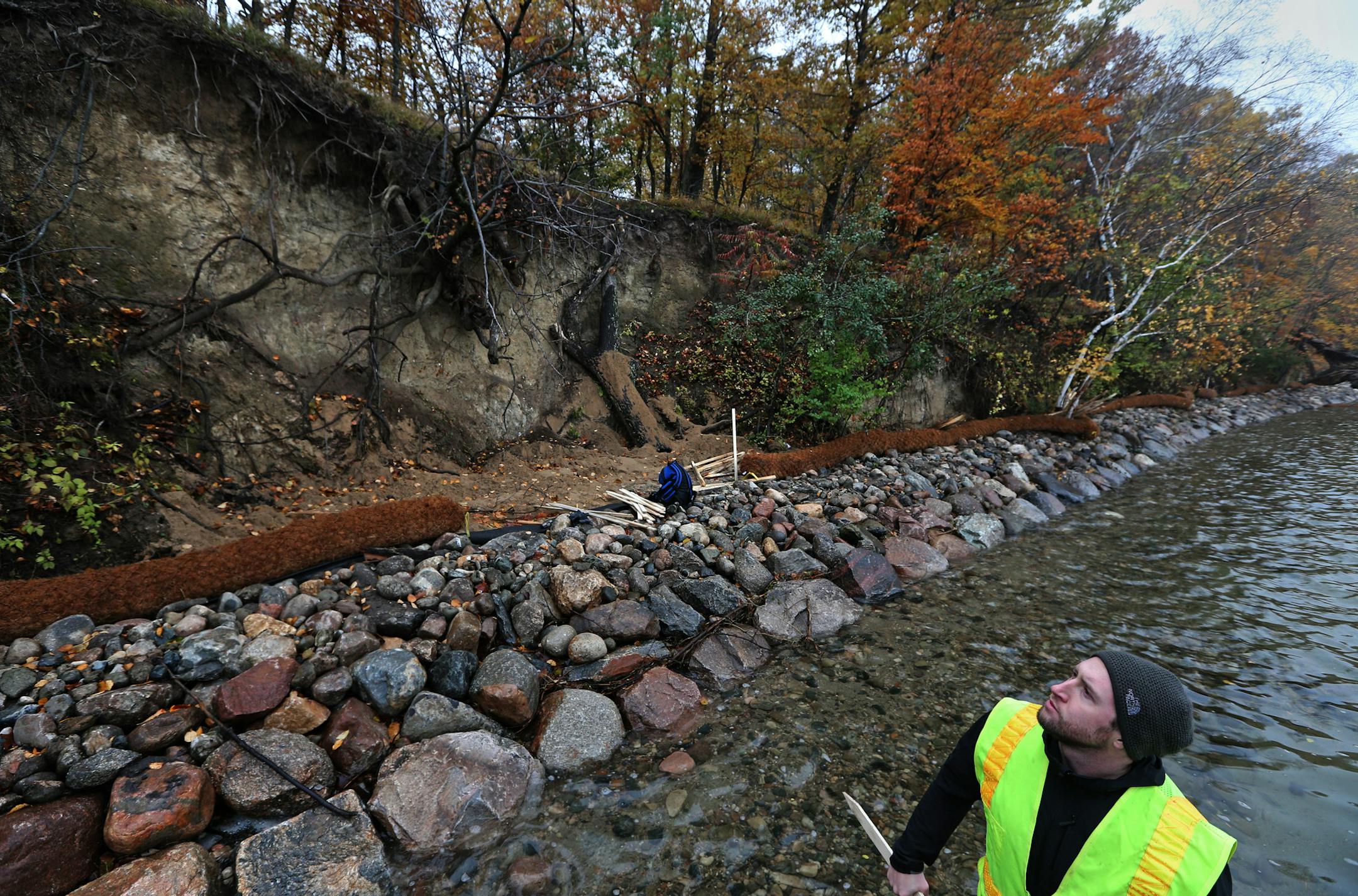 (right) Matt Kumka, Barr Engineering Landscape Architect examined the shore line work on Big Island in Lake Minnetonka where shore restoration is under construction. Along the shores of Big Island in Lake Minnetonka, bluffs are collapsing and trees have fallen into the water. The problem is erosion caused by too many waves, including those produced by boats in the popular Cruiser's Cove area nearby. The Minnehaha Creek Watershed District and Three Rivers Parks have joined forces on a $267,000 pr