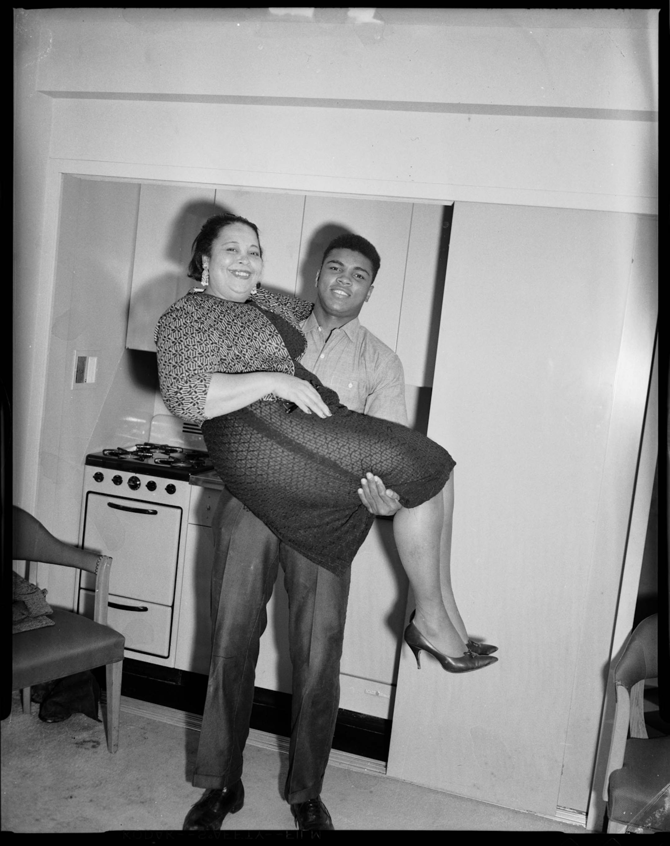 In this 1963 photo taken by Pittsburgh photographer Charles "Teenie" Harris, and provided by the Carnegie Museum of Art, boxer Muhammad Ali (Cassius Clay) lifts his mother, Odessa Grady Clay, in his room at the Carlton House Hotel in Pittsburgh. The "Teenie Harris, Photographer: An American Story" exhibit runs through April 7, 2012, at the Carnegie Museum of Art in Pittsburgh.