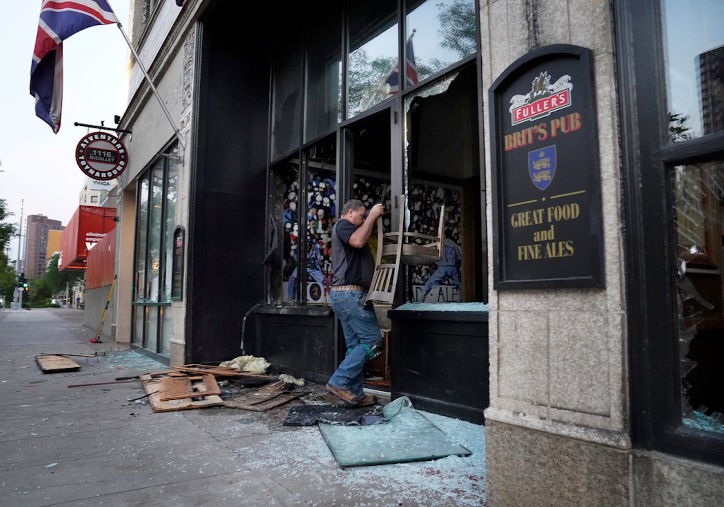 Seth Johnson of MP Johnson Construction cleaned up Thursday outside the fire-damaged Brit's Pub in downtown Minneapolis.