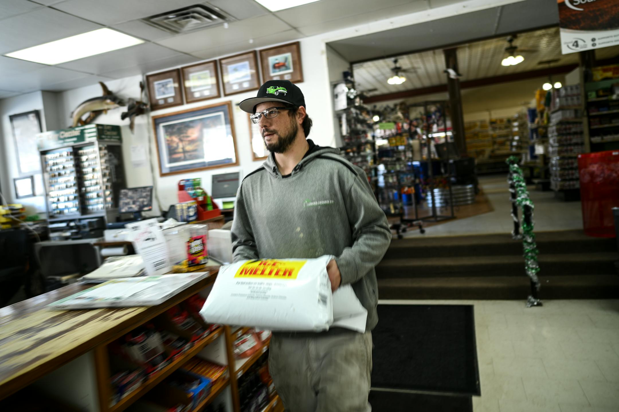 Ben Jerin, of Lonsdale, carries a bag of ice melt to his truck at Lonsdale Hardware and Rental.