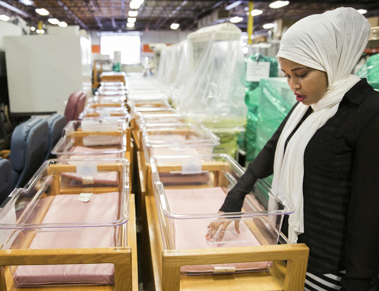 Nimo Ahmed, director of MN Community of African People with Disabilities looks at newborn baby bassinets that will be sent to a hospital in Somalia at the MATTER headquarters in St. Louis Park. ] (Leila Navidi/Star Tribune) leila.navidi@startribune.com BACKGROUND INFORMATION: Monday, June 13, 2016 in St. Louis Park. The Minnesota nonprofit, MATTER, joined forces with the Minnesota Community of African People With Disabilities to equip what will be Somalia's top hospital with medical supplies don