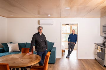 Quartersawn Design Build director of design Ali Awad, left, and designer Austin Kratochwill inside a modern ADU/carriage house they designed from a ga