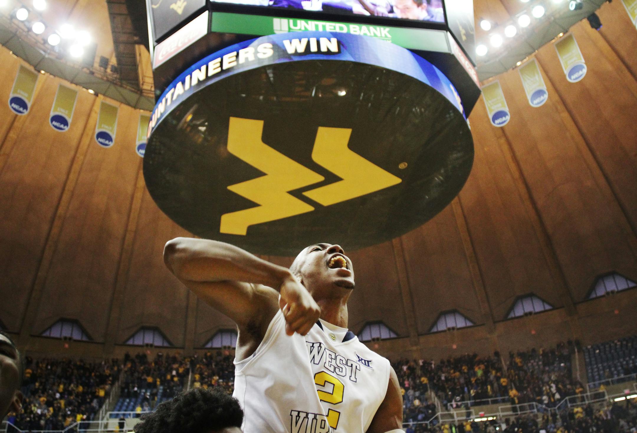 West Virginia guard Jevon Carter (2) celebrates after making both of his free-throws in overtime to defeat TCU 86-85 n an NCAA college basketball game, Saturday, Jan. 24, 2015, in Morgantown, W.Va. . (AP Photo/Raymond Thompson)
