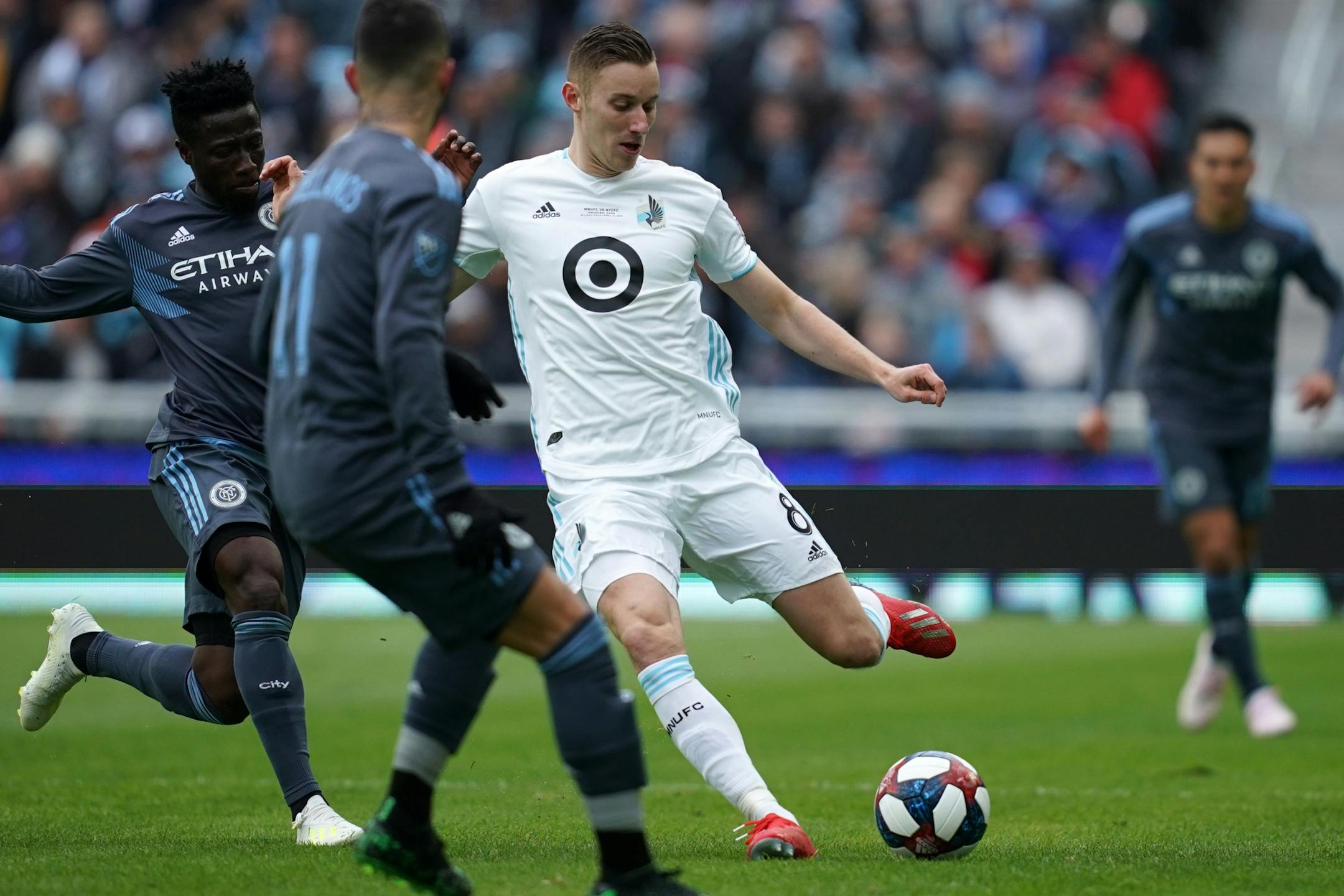 Minnesota United midfielder Jan Gregus (8) looked to pass the ball back to a teammate under pressure in the first half.