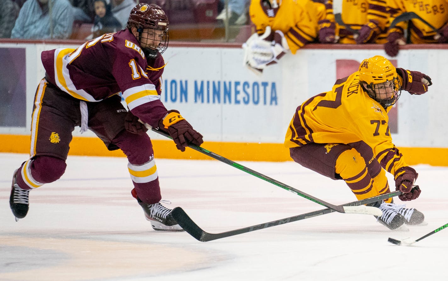 Minnesota Duluth forward Luke Loheit (16) and Minnesota forward Rhett Pitlick (77) reach out for a loose puck in the third period of their game on Friday, October, 22, 2021 at 3M Arena at Mariucci in Minneapolis. ]