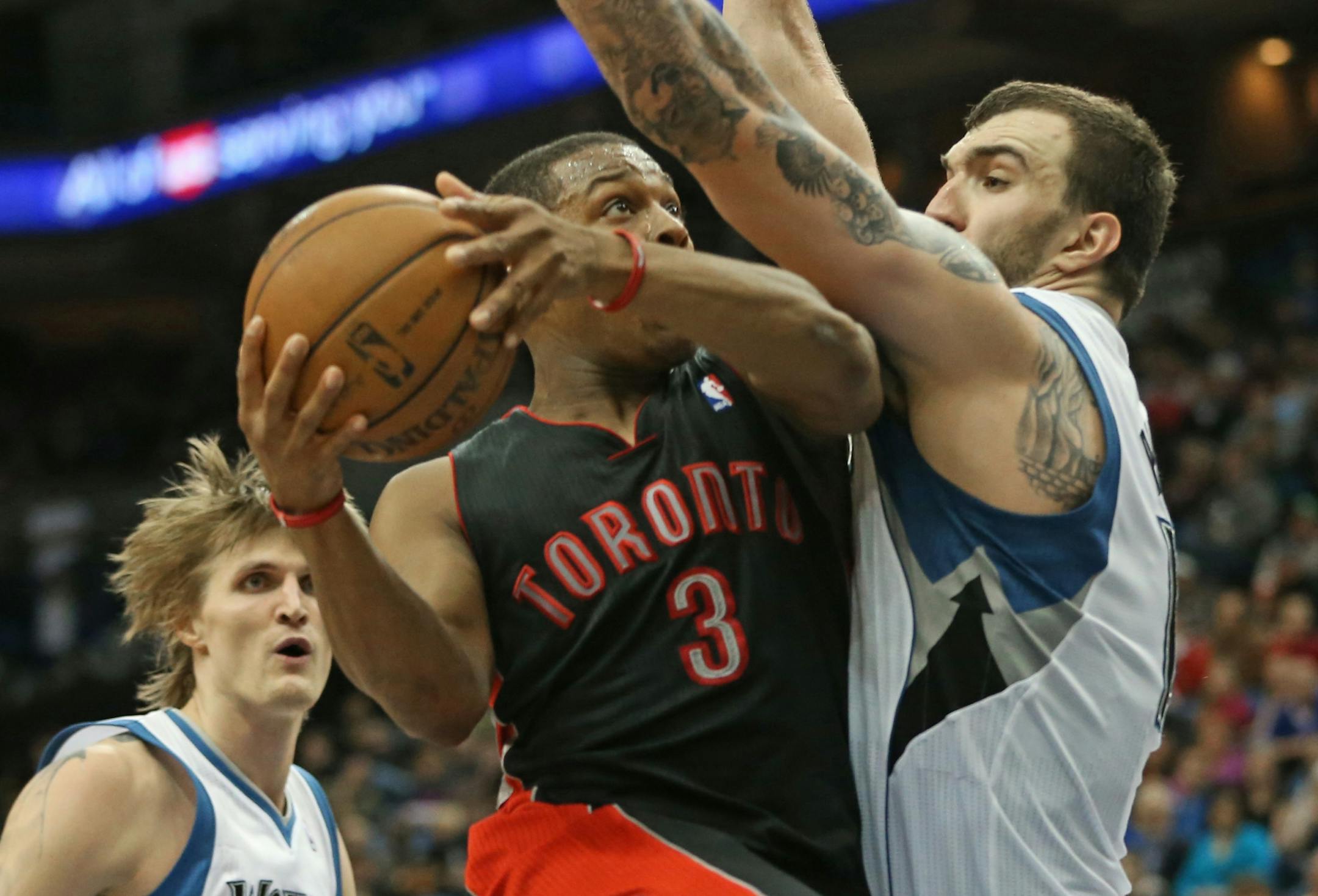 Minnesota Timberwolves vs. Toronto Raptors, 4/5/13. (left to right) Raptors Kyle Lowry drove against Wolves Nikola Pekovic in 2nd half action.