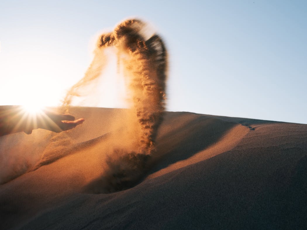 A sound engineer throws sand to demonstrate how sounds were made for “Dune” in Death Valley National Park in California.