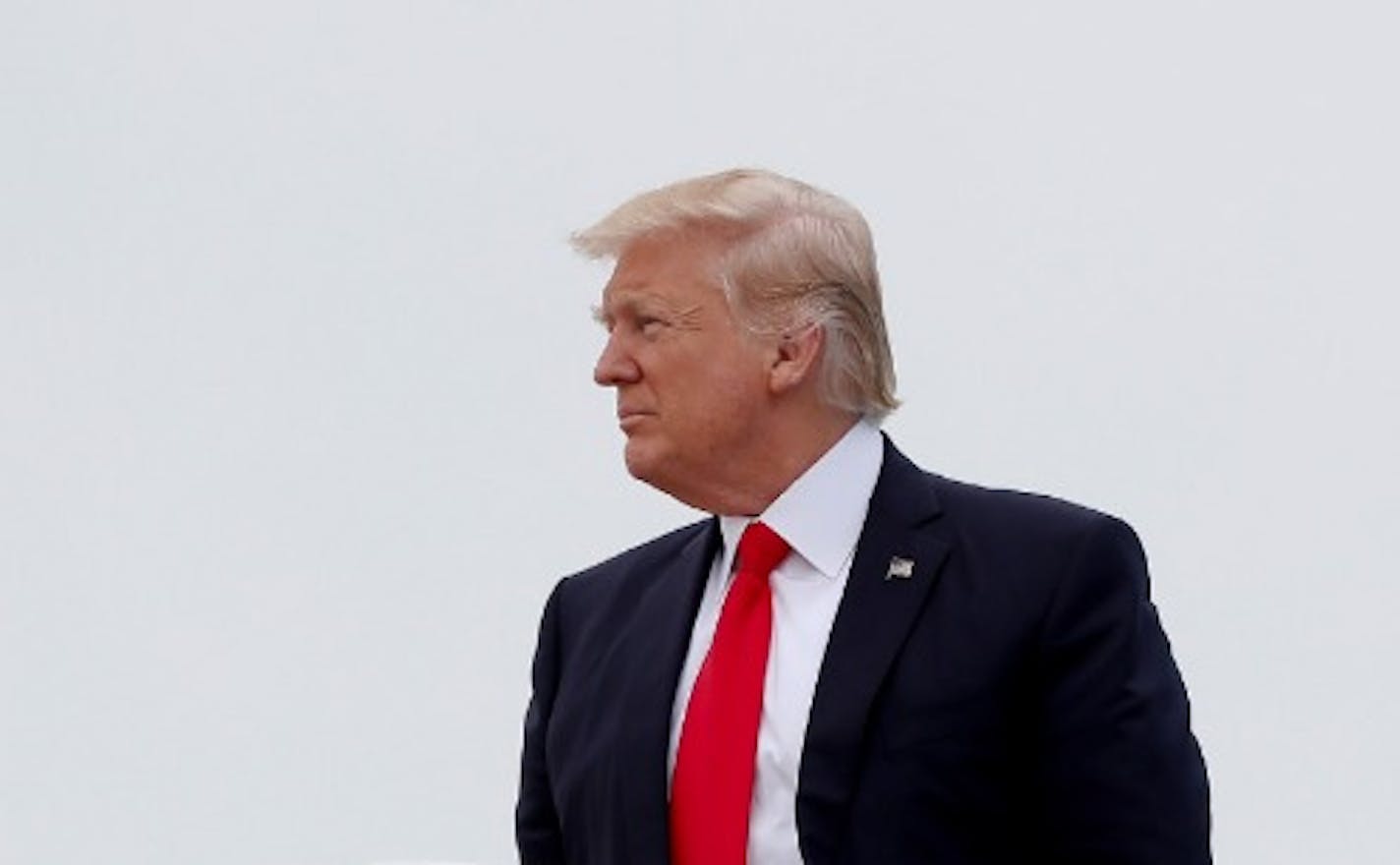 President Donald Trump pauses as he boards Air Force One, Saturday, April, 29, 2017, in Andrews Air Force Base, Md., en route to Harrisburg, Pa.