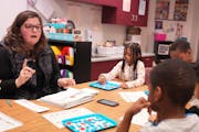 Teacher Lucinda Stelle worked with a group of first-graders on their reading skills at Benjamin E. Mays School in St. Paul.