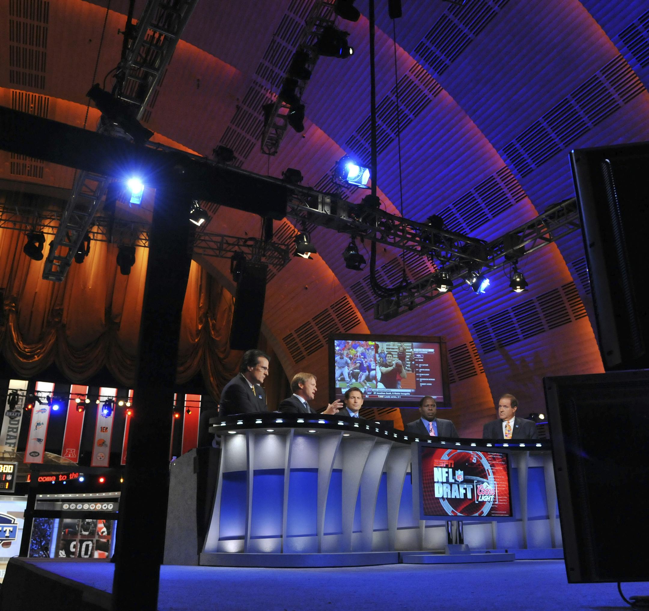 FILE-- ESPN sports analysts talk before the start of The NFL Draft at Radio City Music Hall in New York, April 22, 2010. By first allowing spectators in 1973 and then televising in 1979 what was once an insiders-only process, longtime commissioner Pete Rozelle is essentially the man who turned the draft into the spectacle it is today. (Jason Szenes/The New York Times)