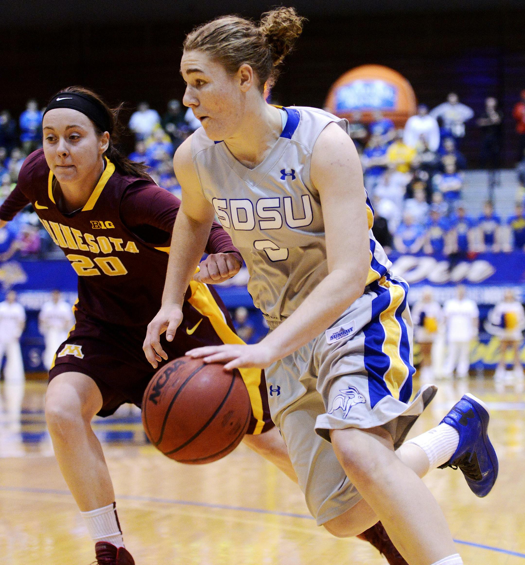 South Dakota State's Chynna Stevens drives past Minnesota's Kayla Hirt in Thursday's 3rd round WNIT basketball game at Frost Arena in Brookings, S.D. March 27, 2014. SDSU beat Minnesota 70-62. (Elisha Page / Argus Leader)