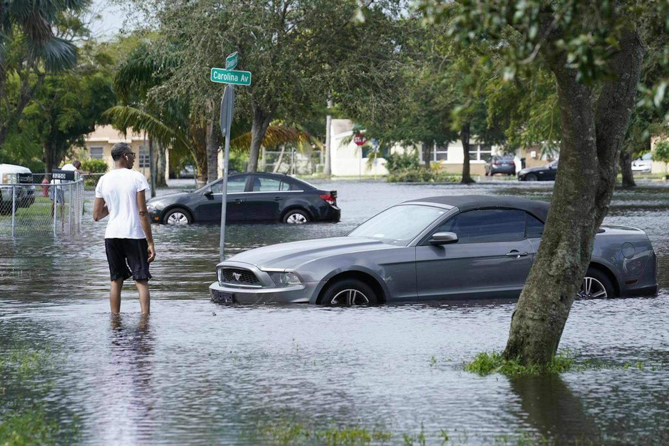 A man walks a flooded street in his neighborhood, Monday, Nov. 9, 2020 in Fort Lauderdale, Fla. Tropical Storm Eta caused severe flooding in South Florida in areas already saturated from previous downpours.