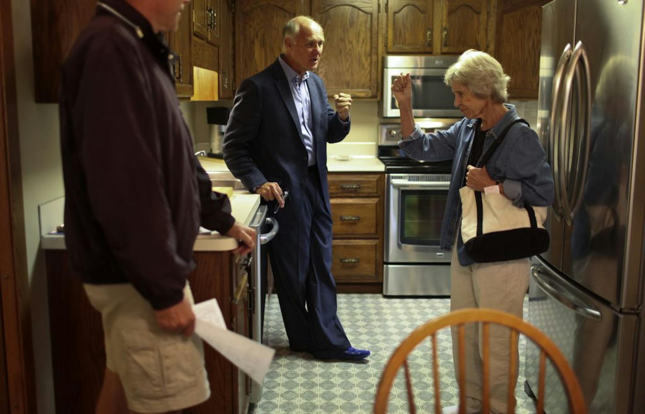 Steve Westmark, an agent for Counselor Realty, center, showed client Emily Reichel of Minnetonka, right, the kitchen in a newly listed condominium with family members at St. Albans Mills in Minnetonka. August home sales jumped in August, but inventories were tightening.