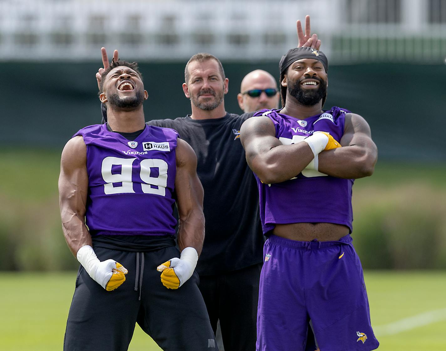 Vikings Danielle Hunter, left, and Za'Darius Smith struck a pose as outside linebackers coach Mike Smith fooled with them Wednesday at the TCO Performance Center in Eagan.