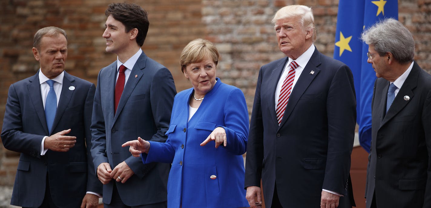 G7 leaders, from left, President of the European Commission Jean-Claude Junker, Canadian Prime Minister Justin Trudeau, German Chancellor Angela Merkel, President Donald Trump, and Italian Prime Minister Paolo Gentiloni, pose for a family photo at the Ancient Greek Theater of Taormina, Friday, May 26, 2017, in Taormina, Italy. (AP Photo/Evan Vucci) ORG XMIT: ITAV147