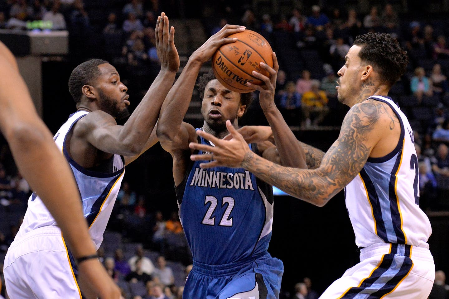 Minnesota Timberwolves guard Andrew Wiggins (22) drives between Memphis Grizzlies forwards JaMychal Green, left, and Matt Barnes in the first half of an NBA basketball game Wednesday, March 16, 2016, in Memphis, Tenn. (AP Photo/Brandon Dill)