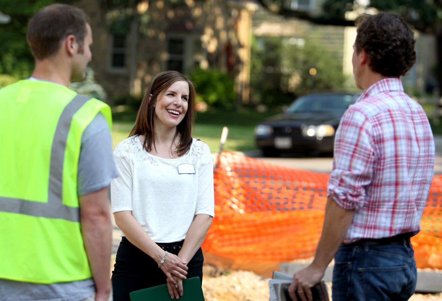 Residential Redevelopment Coordinator for the City of Edina, Cindy Larson, speaks with Scott Busyn, right, the owner of Great Neighborhood Homes and Will Hendrickon, a project management intern at a new home construction site in Edina, Minn., on Thursday, July 11, 2013. Larson is a mediator between home builders and neighbors. "My job is part construction, part counselor," she said. ] (ANNA REED/STAR TRIBUNE) anna.reed@startribune.com (cq)