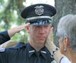 An officer teared up at the funeral for Mendota Heights police officer Scott Patrick in 2014. After the shooting, West St. Paul officers involved in t