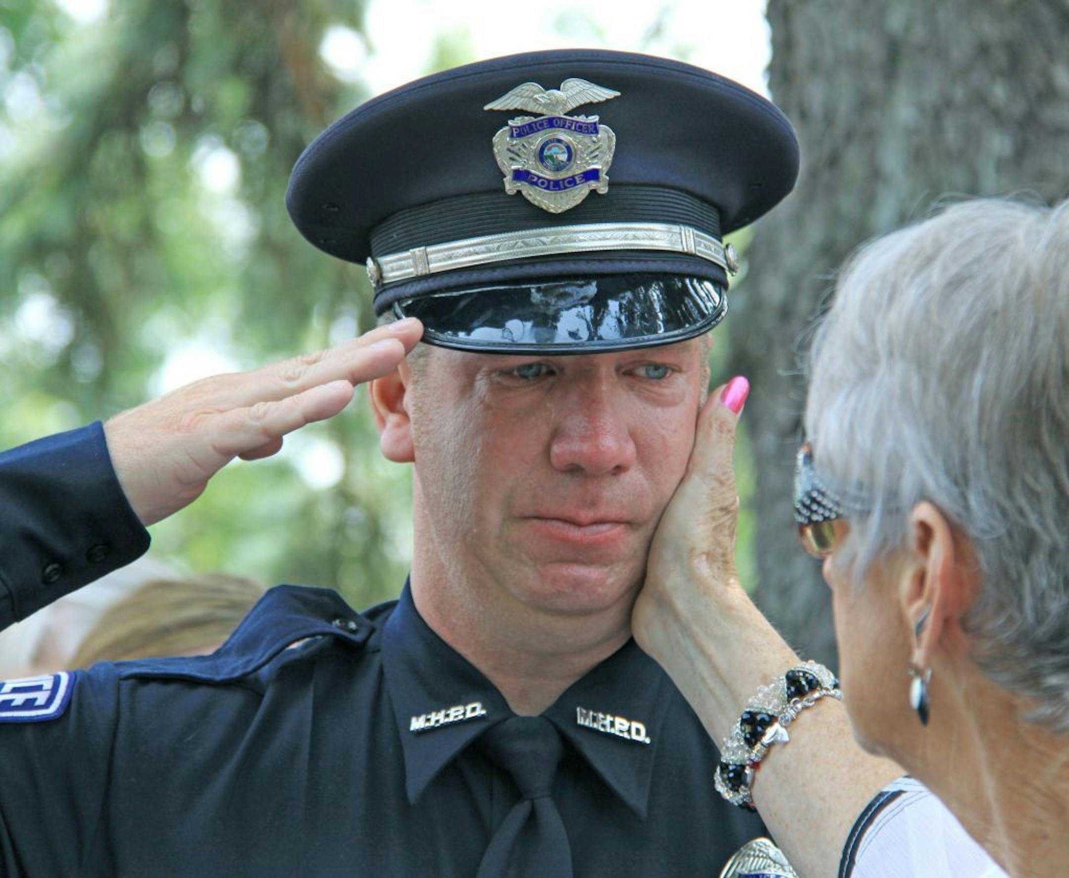 An officer teared up at the funeral for Mendota Heights police officer Scott Patrick in 2014. After the shooting, West St. Paul officers involved in the incident were required to see a counselor.