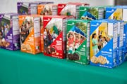 An array of Girl Scout cookie boxes lined up on a table.