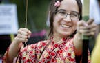 Kyesha Lindgren, 21, of Coon Rapids was instructed on the proper usage of a bow at the Como Park Japanese Obon Festival.