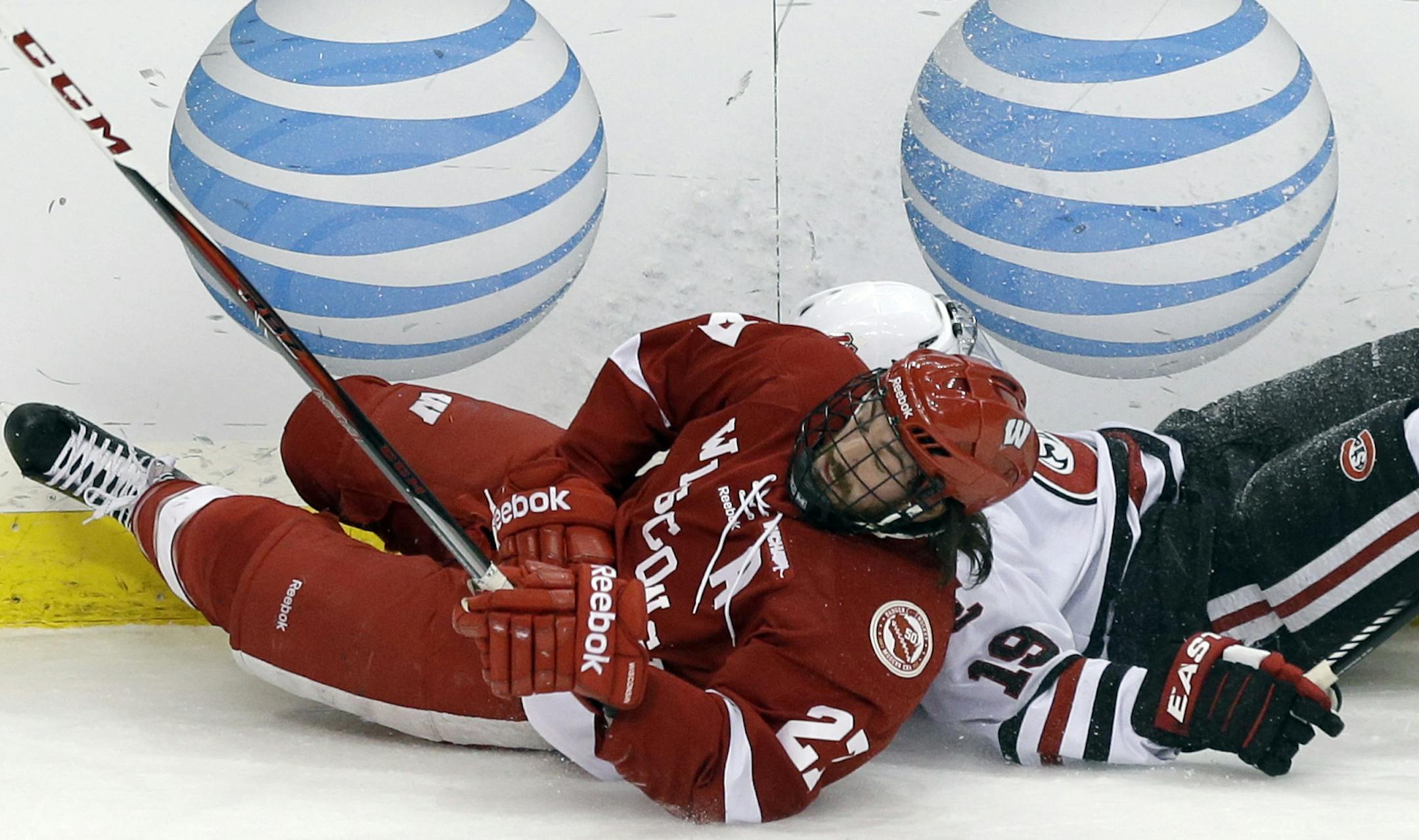 St. Cloud State's Drew LeBlanc, right, and Wisconsin's Frankie Simonelli collide along the boards in the first period of a WCHA Final Five semi-finals college hockey game Friday, March 22, 2013, in St. Paul, Minn. (AP Photo/Jim Mone)