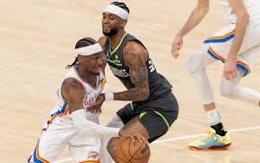 Cousins Shai Gilgeous-Alexander, left, of the Thunder and Nickeil Alexander-Walker of the Wolves battled during Tuesday's game in Oklahoma City.