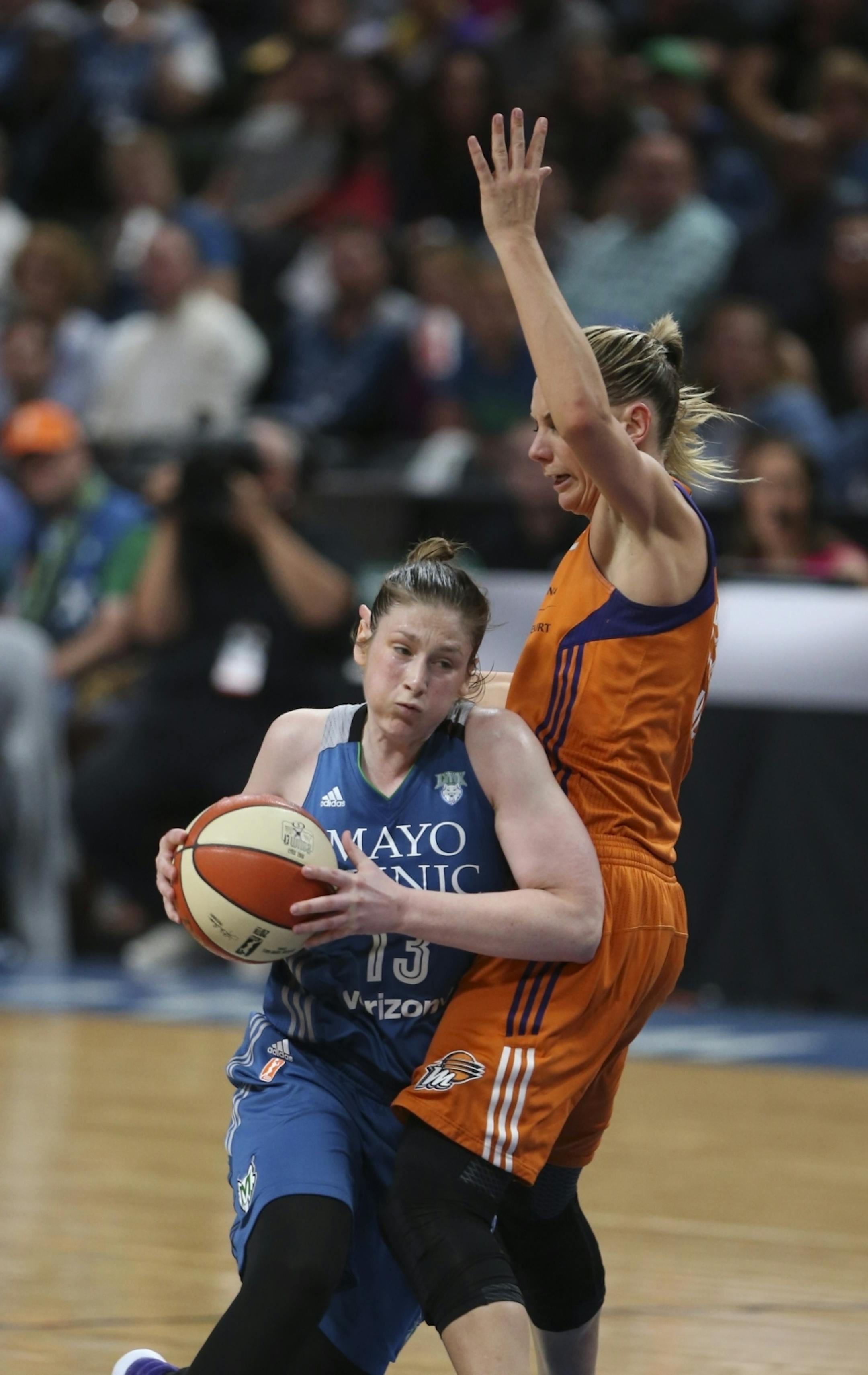 Minnesota Lynx guard Lindsay Whalen (13) was fouled by Phoenix Mercury forward Penny Taylor (13) in the fourth quarter while driving to the net.