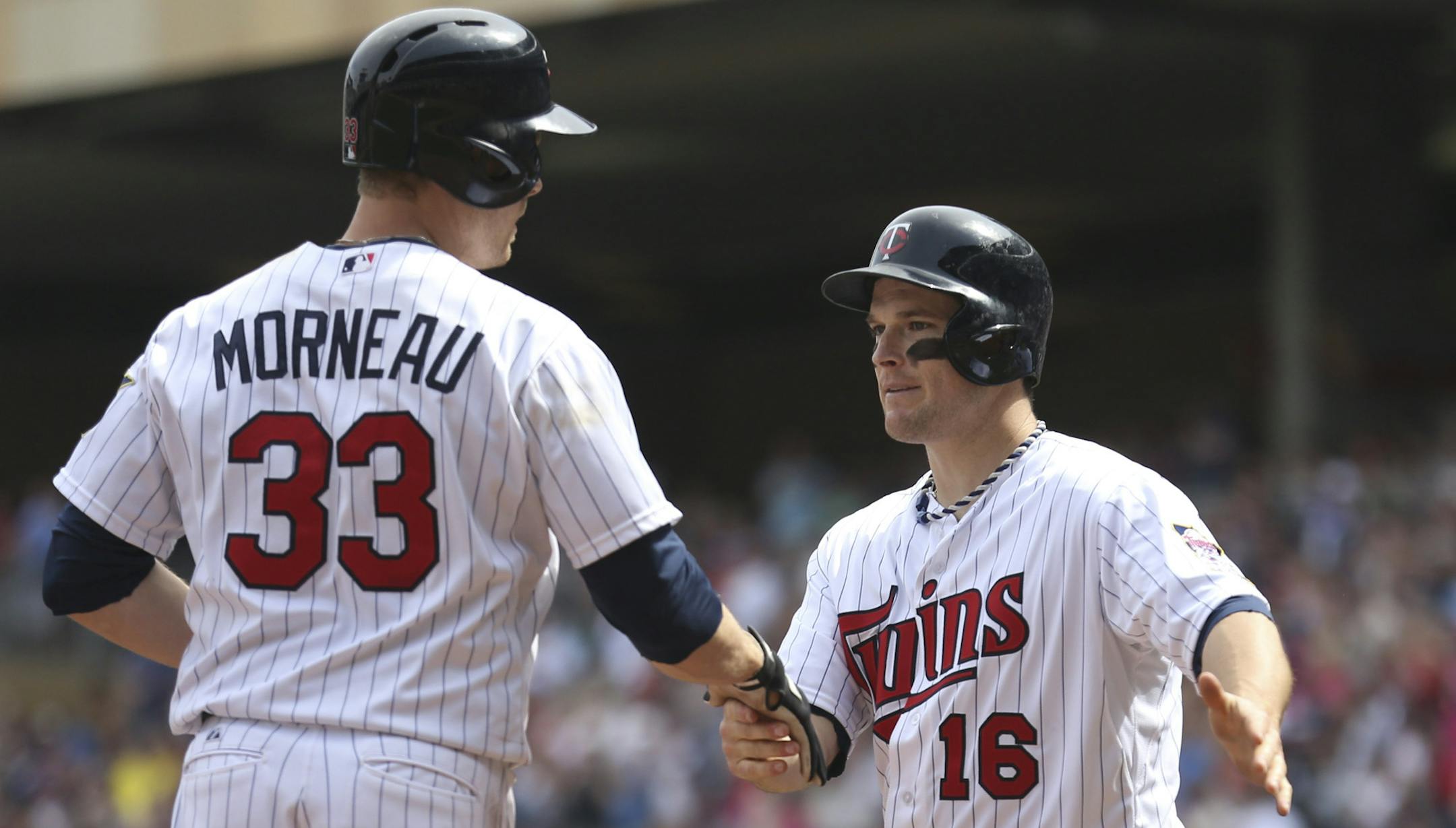 Twins first baseman Justin Morneau was greeted by Josh Willingham after both scored on Morneau’s sixth-inning homer off Texas starter Alexi Ogando, giving the Twins a 3-0 lead Sunday.
