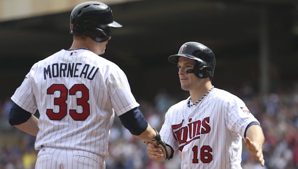 Twins first baseman Justin Morneau was greeted by Josh Willingham after both scored on Morneau&#x2019;s sixth-inning homer off Texas starter Alexi Oga