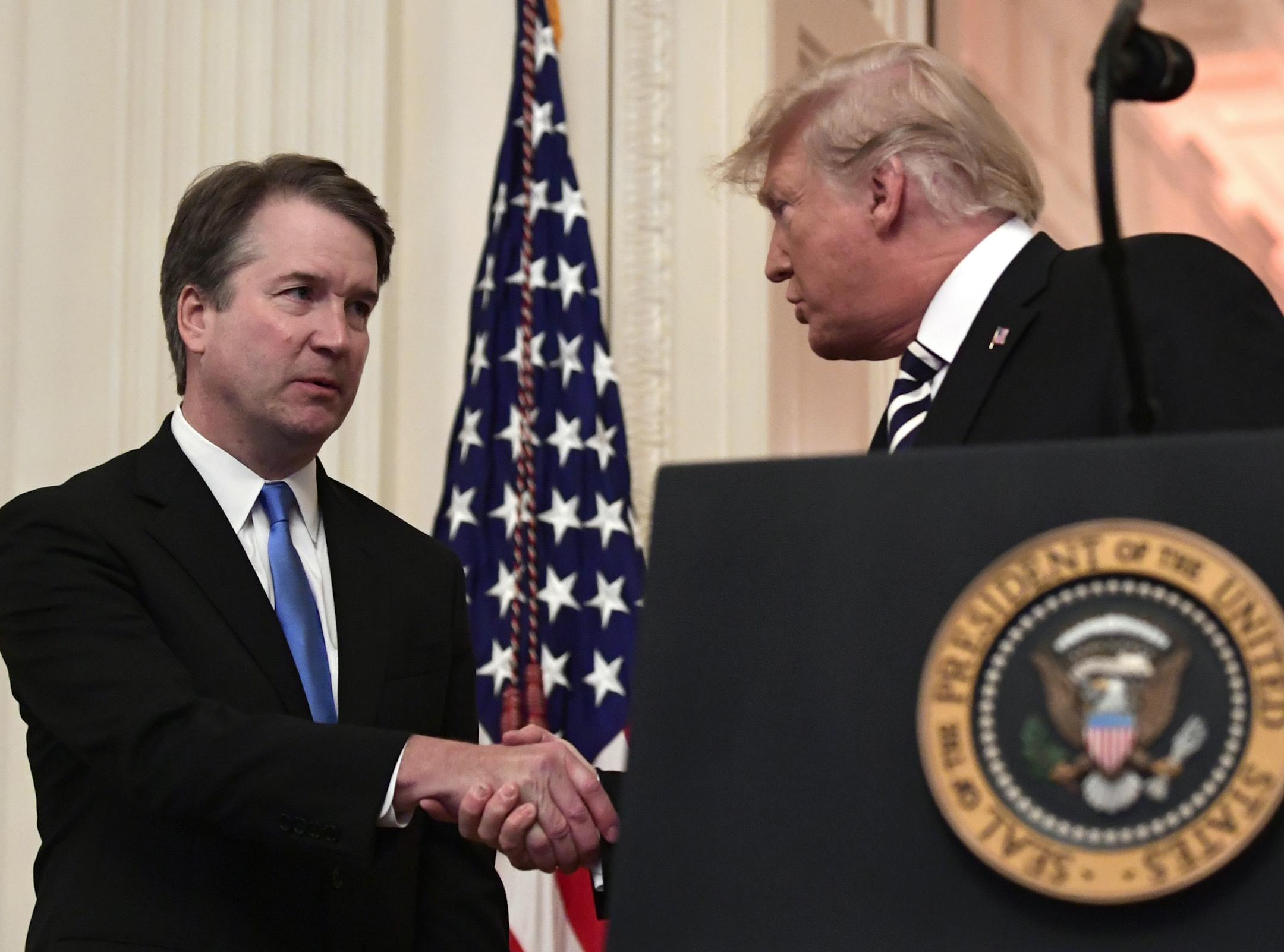 President Donald Trump, right, shakes hands with Supreme Court Justice Brett Kavanaugh, left, before a ceremonial swearing in in the East Room of the White House in Washington, Monday, Oct. 8, 2018. (AP Photo/Susan Walsh) ORG XMIT: MIN2018110610430309