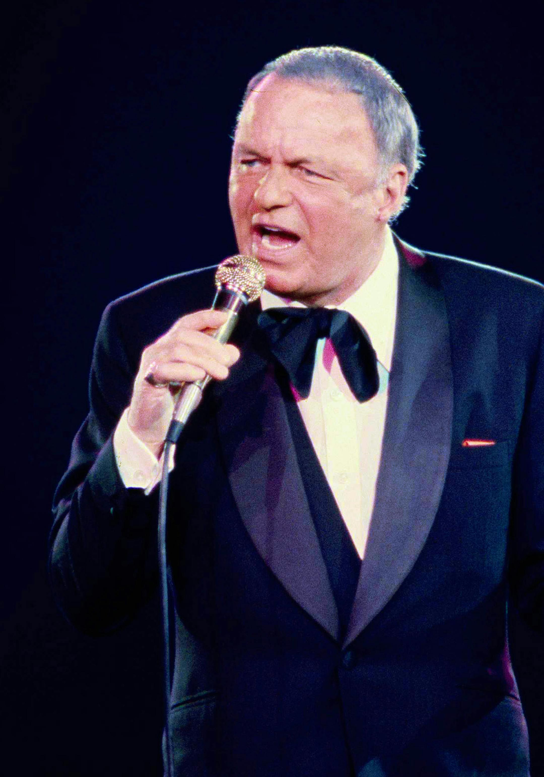 FILE - In this June 23, 1979 file photo, singer Frank Sinatra performs during his concert at the Nassau Coliseum, in Uniondale, N.Y. 100 is turning out to be a very good year for Sinatra. Wednesday night, Dec. 2, 2015, his birthday gets the star treatment with a live Grammy-produced concert at the Wynn resort-casino in Las Vegas. The two-hour concert airs Sunday from 9 to 11 p.m. EST/PST on CBS. (AP Photo/Richard Drew, File) ORG XMIT: CAET276