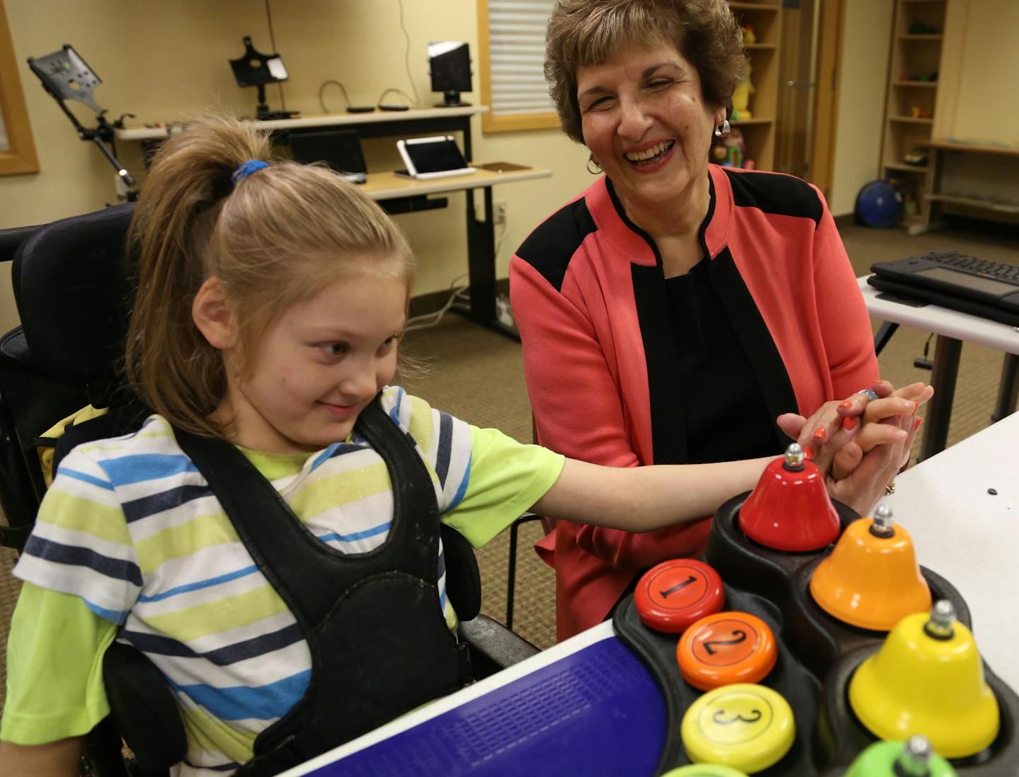 Paula Goldberg, founder of PACER, sat next to Amanda Larson, 8, of Houston, Min., as she played the bells during her session. ] (KYNDELL HARKNESS/STAR TRIBUNE) kyndell.harkness@startribune.com At the PACER office in Bloomington , Min., Thursday August 27, 2015.