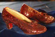 A pair of ruby slippers once worn by actress Judy Garland in the "The Wizard of Oz" are displayed at a news conference Tuesday, Sept. 4, 2018, at the 