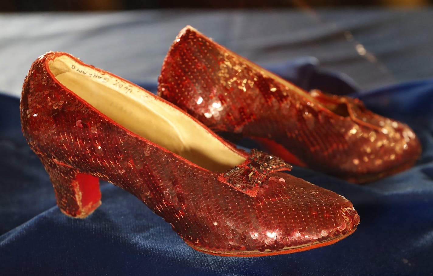 A pair of ruby slippers once worn by actress Judy Garland in the "The Wizard of Oz" are displayed at a news conference Tuesday, Sept. 4, 2018, at the FBI office in Brooklyn Center.