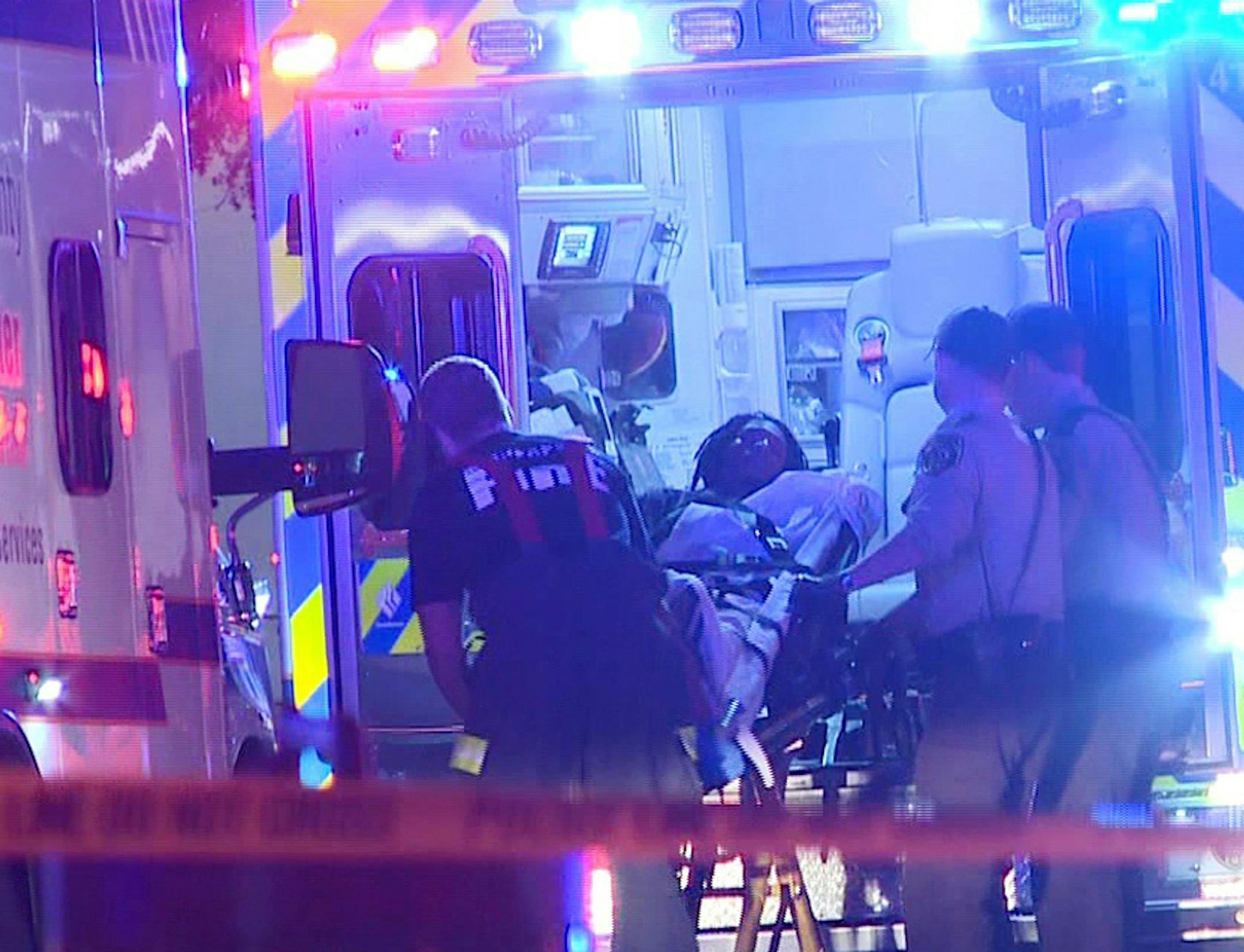 In this photo provided by KARE, a person is brought into an emergency vehicle after a shooting early Monday, Oct. 3, 2016, in Minneapolis. Minneapolis police said multiple people have been wounded in shootings in downtown Minneapolis. (KARE via AP) ORG XMIT: MIN2016100514453356