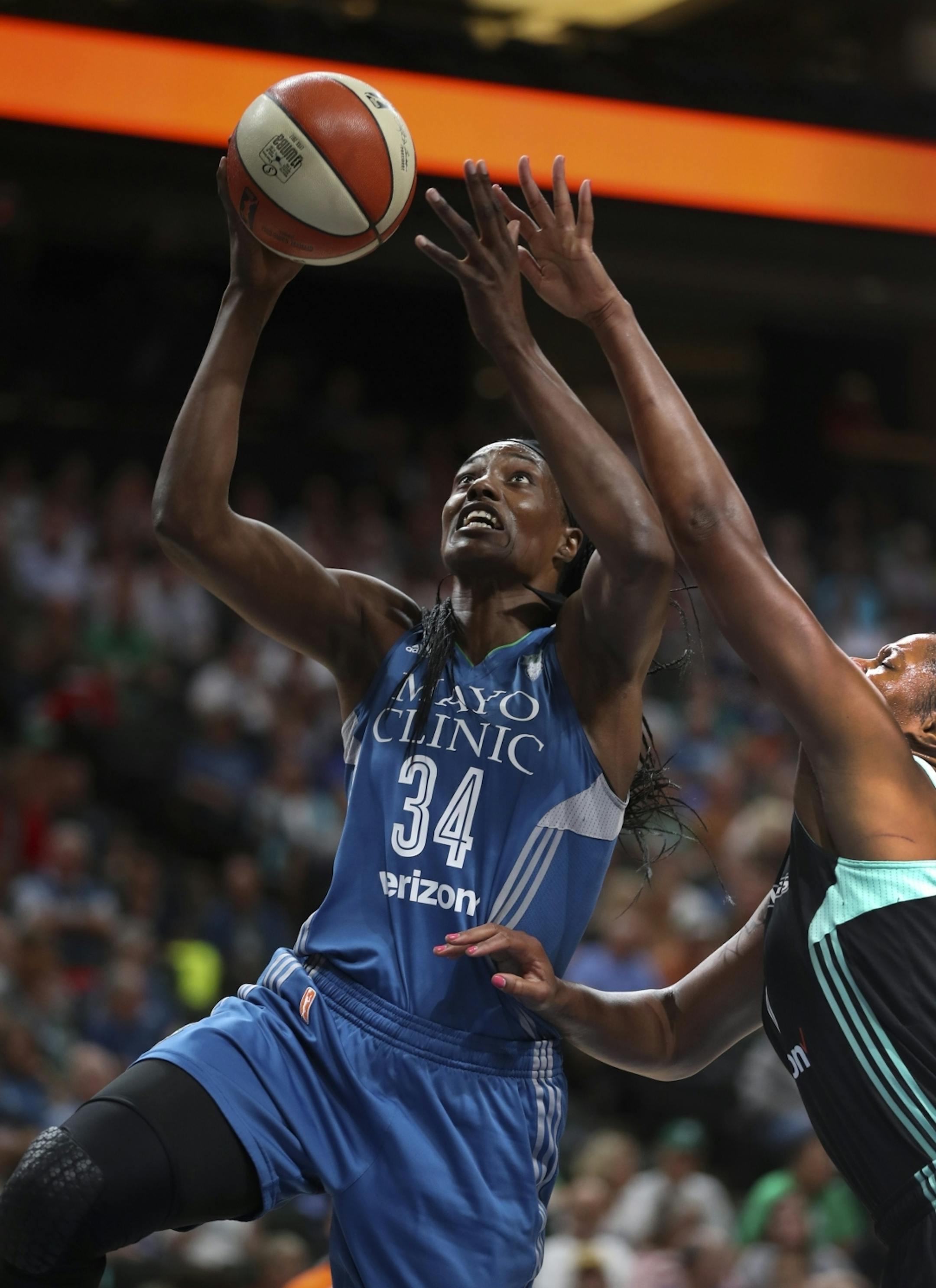 Minnesota Lynx center Sylvia Fowles (34) took a first quarter shot while defended by New York Liberty center Kia Vaughn (7).