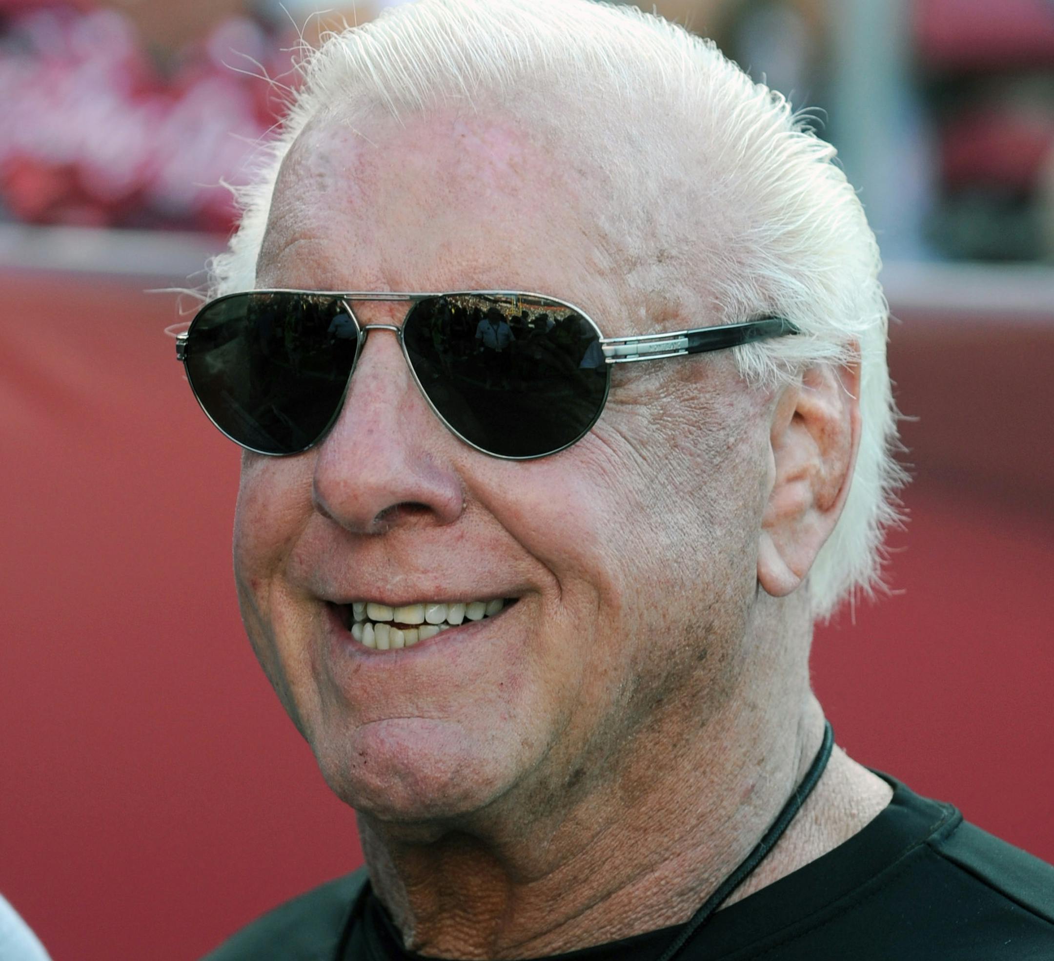 Former professional wrestler Ric Flair poses for photographs on the sideline before an NCAA college football game between Texas A&M and South Carolina, Thursday, Aug. 28, 2014, in Columbia, S.C. (AP Photo/Rainier Ehrhardt) ORG XMIT: SCRE114