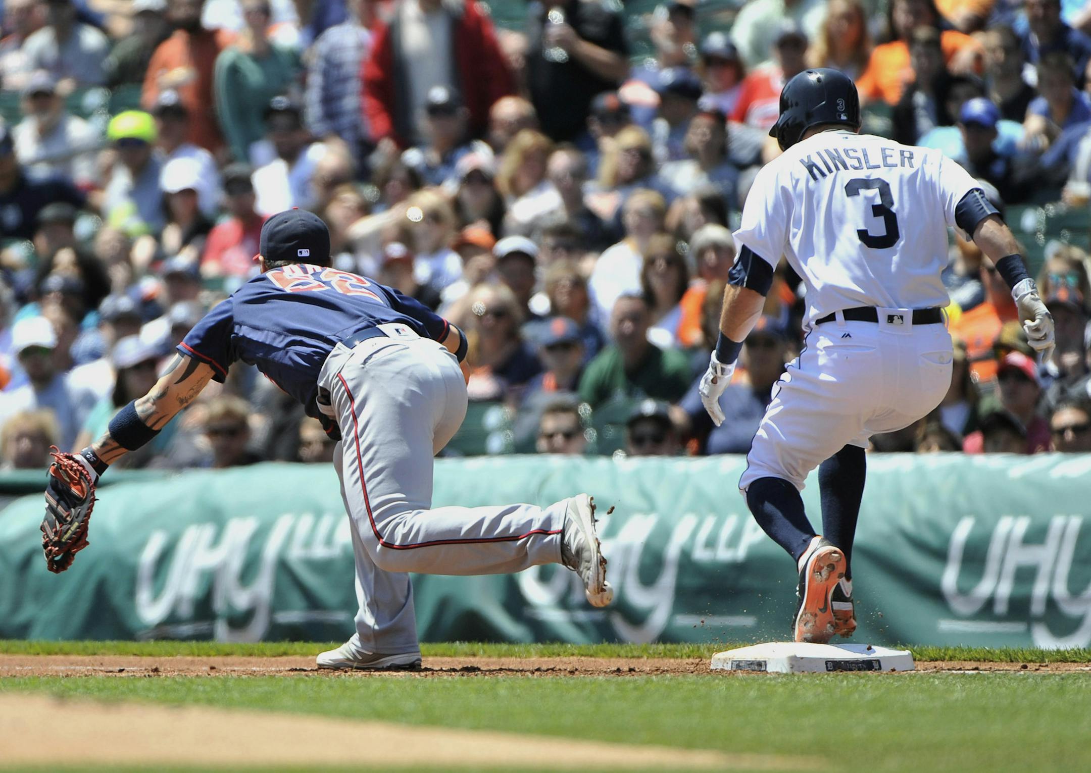 The ball gets past Twins first baseman Byung Ho Park and Tigers' Ian Kinsler advances to second in the first inning. Detroit Tigers vs Minnesota Twins at Comerica Park in Detroit on May 18, 2016. (Robin Buckson / Detroit News)