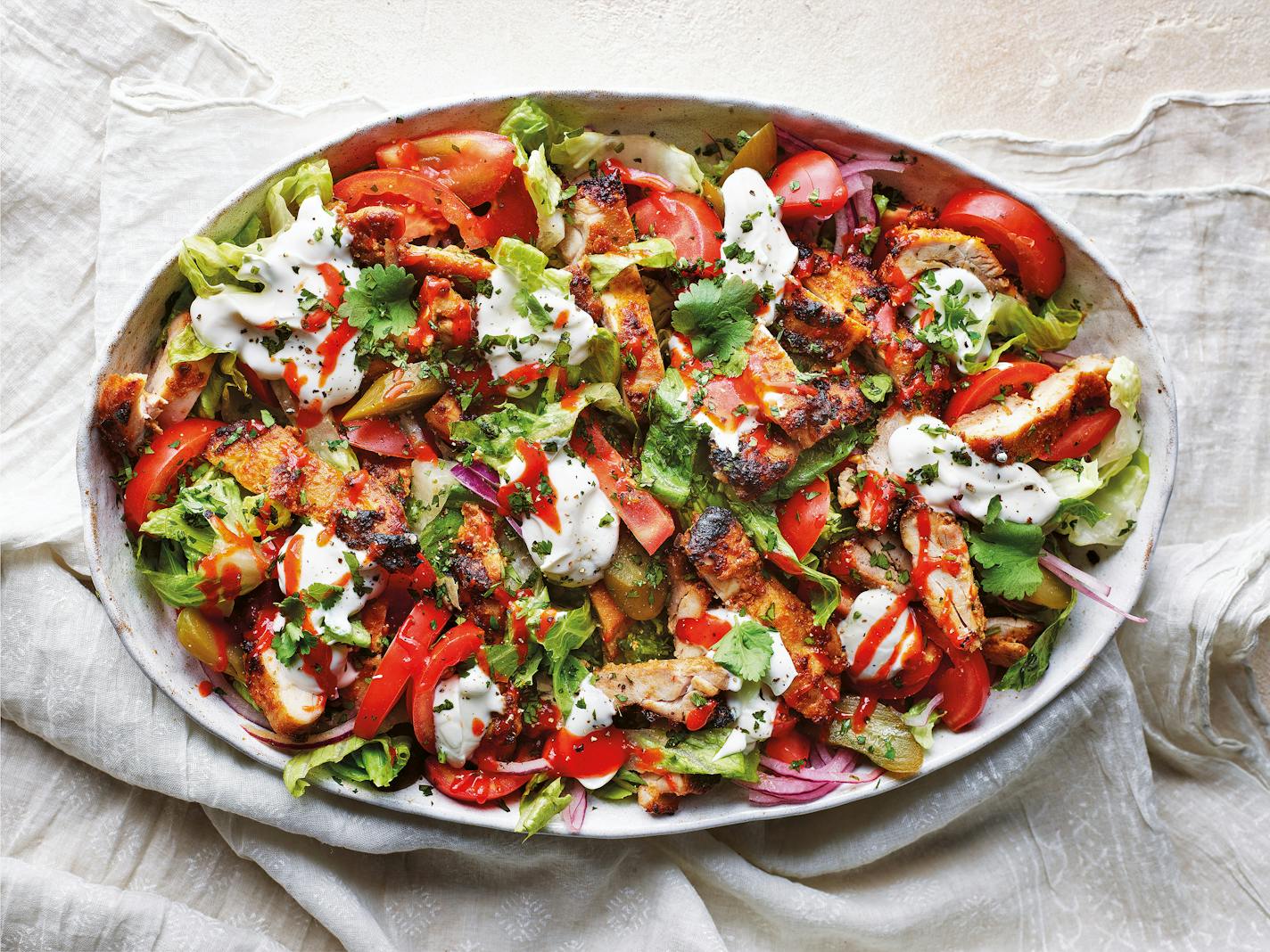 Delicious chicken shawarma salad on a plate, bursting with Middle Eastern flavors. From the cookbook "Flavor," by Sabrina Ghayour.