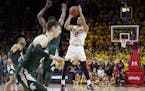 Maryland guard Melo Trimble (2) shoots the game-winning shot in the final moments of an NCAA college basketball game against Michigan State, Saturday,