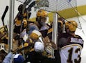 Teammates converged on Thomas Vanek after the freshman scored in overtime to give the Gophers a 3-2 NCAA semifinal win over Michigan in the 2003 Froze