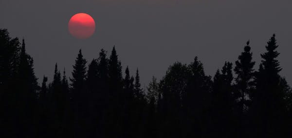 Wildfire smoke from Canada's Quetico Provincial Park caused a haze in the air as the sun set over Seagull Lake in The Boundary Waters Canoe Area Wilde
