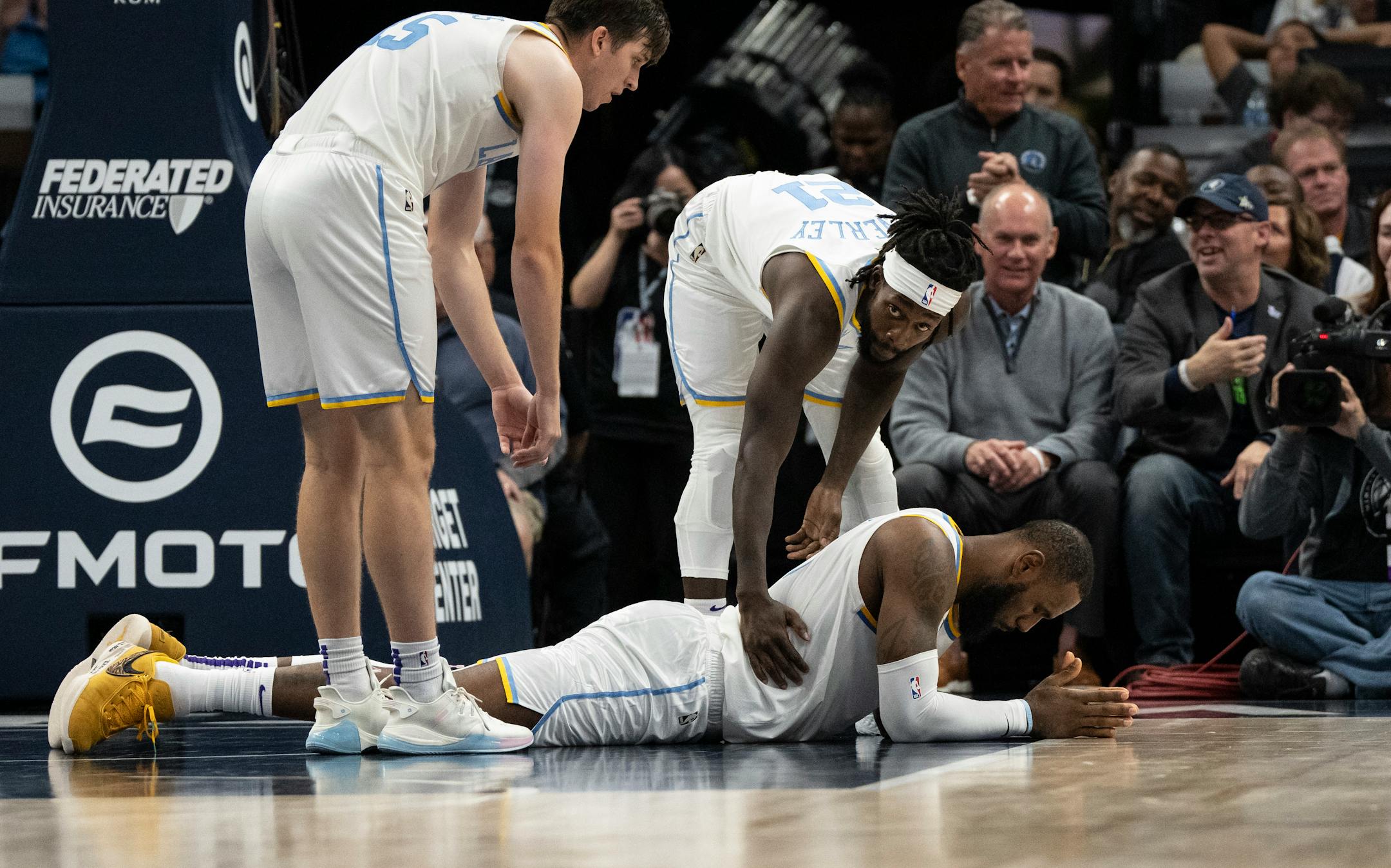 Los Angeles Lakers forward LeBron James (6) reacts after getting knocked down by Minnesota Timberwolves forward Jaden McDaniels (3) in a struggle for the ball in the fourth quarter.